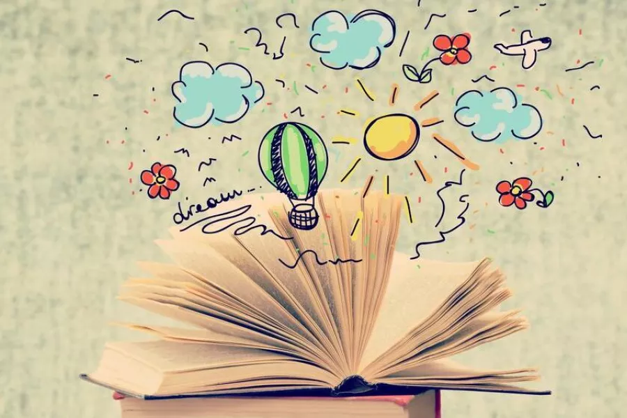 Imagen de un libro abierto que posee ilustraciones de un globo aeroestático, nubes, flores y un avión