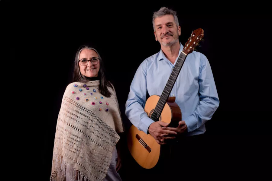 Es la imagen de un musico y una musica posando para una foto 
