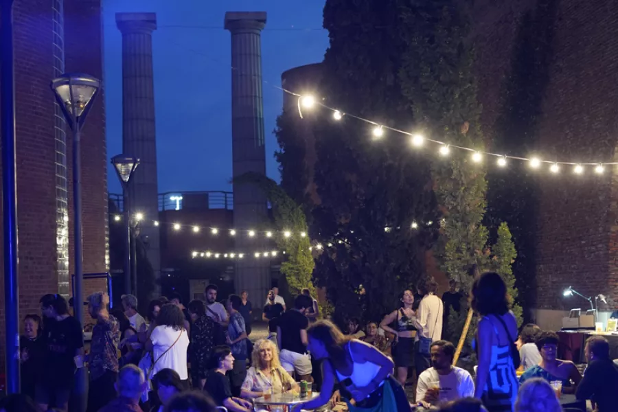 Personas cenando en el Patio de los cipreses del ccpe