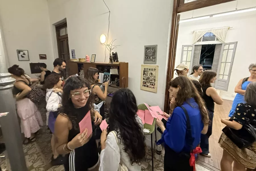 Es la imagen del interior de un edificio donde hay personas hablando entre ellas