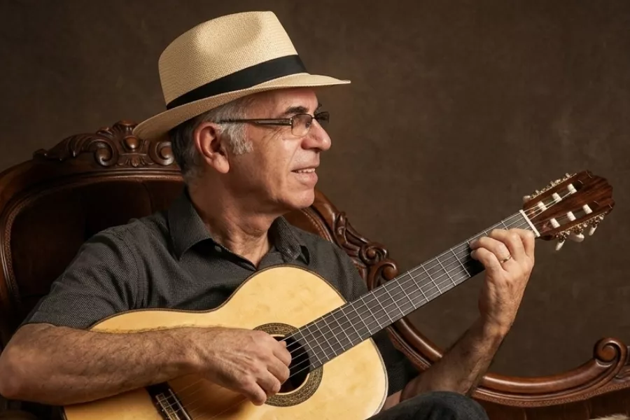 Es la imagen de un músico tocando una guitarra 